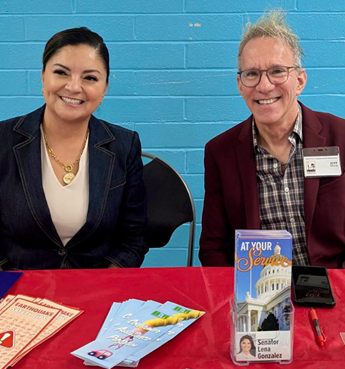 Senator Gonzalez photographed at a tabling booth