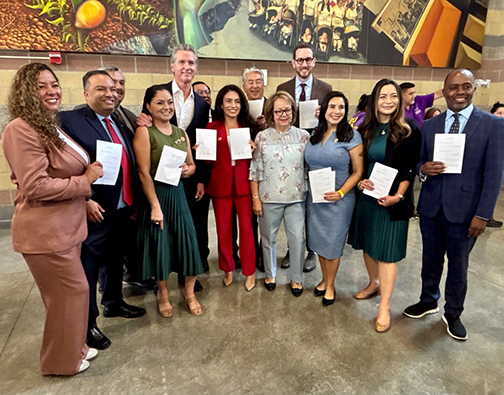 Senator Lena Gonzalez celebrates the signing of the immigration bill package alongside Governor Newsom and members of the California Latino and AAPI Legislative Caucuses.